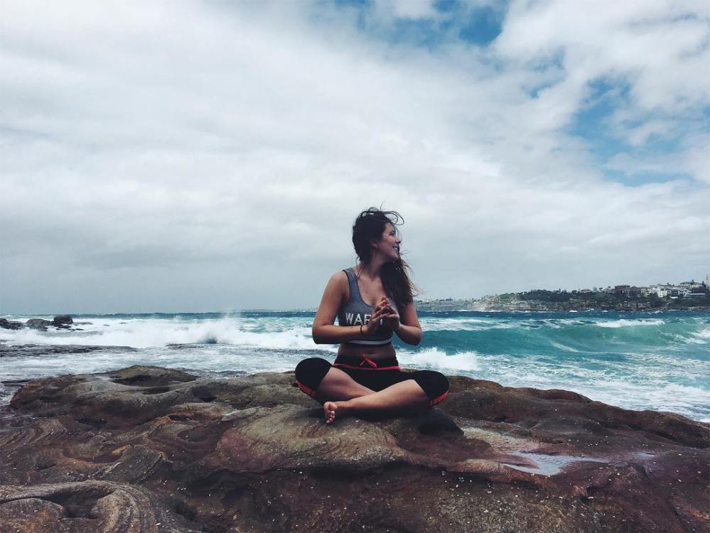 Woman sitting on the shore near Bondi Beach in Sydney