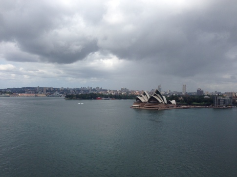The Sydney Opera House sits below a sky of clouds