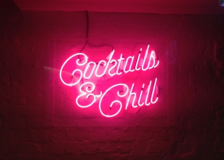 Pink neon bar sign that reads 'Cocktails and Chill'