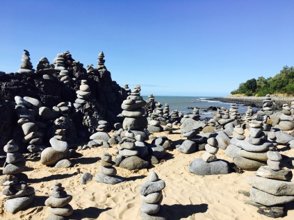 Piles of stacked rocks on Wangetti Beach